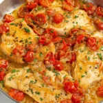 Chicken Pomodoro skillet with golden chicken cutlets, blistered cherry tomatoes, garlic, and onion in a bright lemony pan sauce.