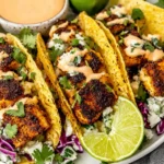 Blackened Fish Tacos on crispy corn tortillas with cilantro, lime, purple cabbage, and creamy chipotle cilantro-lime sauce.