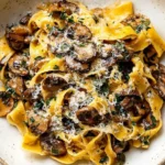 Garlic Mushroom Pasta with pappardelle, sautéed cremini mushrooms, parmesan, and parsley in a buttery garlic sauce.