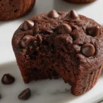 Greek Yogurt Choco Muffins with melty chocolate chips, rich and fluffy chocolate muffins on a marble surface