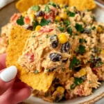 Southwestern Chicken Salad scooped on a tortilla chip with shredded chicken, black beans, corn, and cilantro in a creamy Greek yogurt dressing.