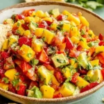 Avocado Strawberry Mango Salsa with diced mango, strawberries, avocado, cilantro, and lime in a bowl, served with tortilla chips for dipping.
