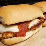 Chicken Parmesan Sandwiches on a soft French roll with crispy breaded chicken, marinara sauce, and melted mozzarella cheese.