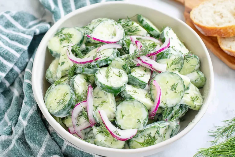 Creamy Cucumber Dill Salad with sliced cucumbers, red onion, and fresh dill in a yogurt-lemon dressing.