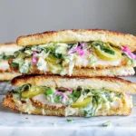 Crispy Chicken Sandwich with Pickled Slaw on toasted brioche with melty mozzarella and tangy banana pepper slaw
