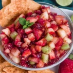 Fruit Salsa with Cinnamon Sugar Tortilla Chips in a bowl with diced strawberries, kiwi, and apples, served with crispy cinnamon-sugar tortilla wedges.