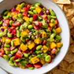 Mango Strawberry Avocado Edamame Salsa in a bowl with tortilla chips—fresh, sweet, zesty, and colorful summer salsa.