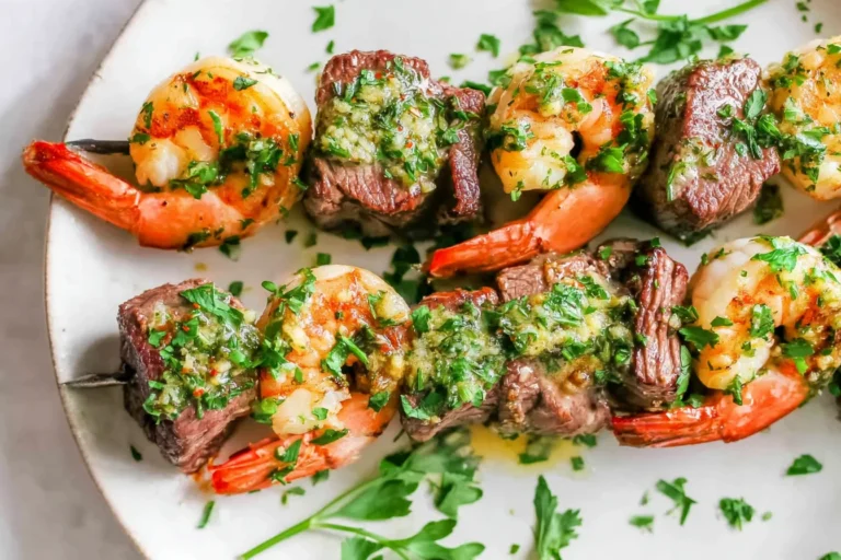 Grilled Steak & Shrimp Kabobs on skewers with garlicky herb butter and fresh parsley, grilled to juicy perfection.