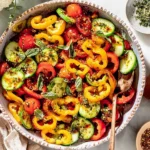 Viral TikTok Cucumber and Bell Pepper Salad with mini cucumbers, sweet bell peppers, cherry tomatoes, chili oil, and sesame dressing in a serving bowl