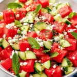 Watermelon Cucumber Feta Salad with juicy watermelon cubes, crunchy cucumber slices, mint leaves, and crumbled feta in a serving bowl