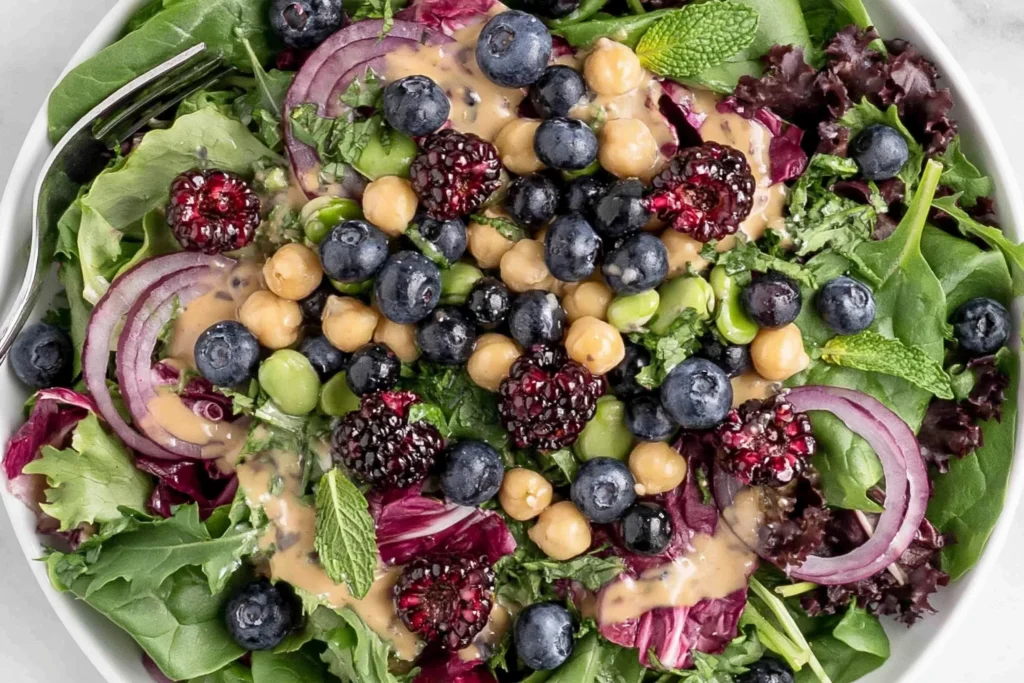 Chickpea Blueberry Salad with fresh blueberries, blackberries, chickpeas, mixed greens, red onion, herbs, and creamy tahini dressing