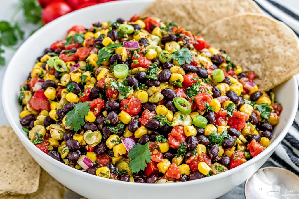 Black Bean Corn Salsa served in a bowl with black beans, sweet corn, cilantro, red onion, and tortilla chips, a fresh and colorful appetizer for parties and summer gatherings.