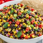 Black Bean Corn Salsa served in a bowl with black beans, sweet corn, cilantro, red onion, and tortilla chips, a fresh and colorful appetizer for parties and summer gatherings.