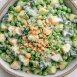 Overhead view of Cucumber Edamame Salad with Creamy Miso Dressing featuring crisp cucumbers, tender edamame, creamy avocado, chopped cashews, and sesame seeds in a savory homemade miso dressing.