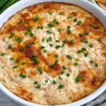 Crab Rangoon Dip baked until golden and bubbly, topped with fresh chives and served warm with crackers