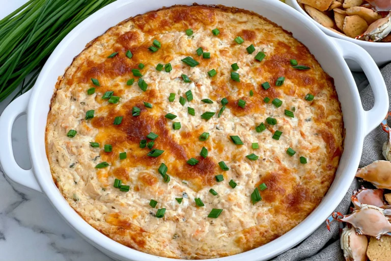 Crab Rangoon Dip baked until golden and bubbly, topped with fresh chives and served warm with crackers
