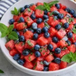Watermelon Blueberry Salad with fresh blueberries, mint, honey, and lime served in a bowl for a refreshing summer side dish.