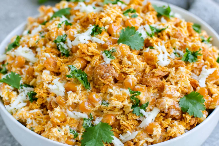 Fritos Corn Salad made with sweet corn, Chili Cheese Fritos, shredded Mexican cheese, creamy mayo, and fresh cilantro in a serving bowl.