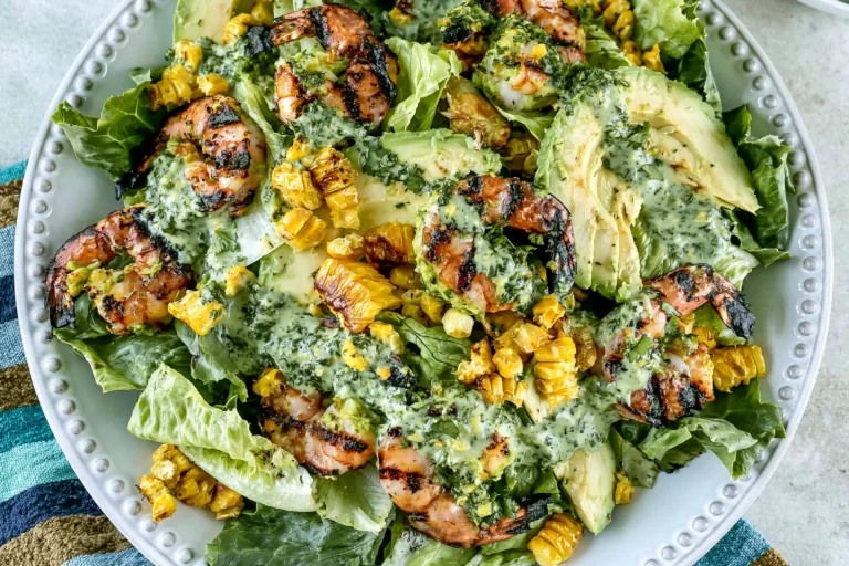Grilled Shrimp Summer Salad with grilled shrimp, charred corn, avocado, romaine lettuce, and creamy green goddess dressing on a serving platter.