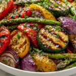 Grilled Veggies with Marinade served in a bowl with zucchini, bell peppers, asparagus, red onion, and balsamic glaze